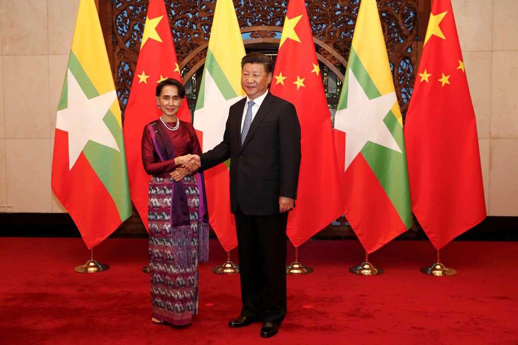 Myanmar State Counsellor Aung San Suu Kyi (L) and Chinese Premier Xi Jinping (R) poses for the media before a meeting at the Diaoyutai State Guesthouse in Beijing, China, on 19 August 2016.